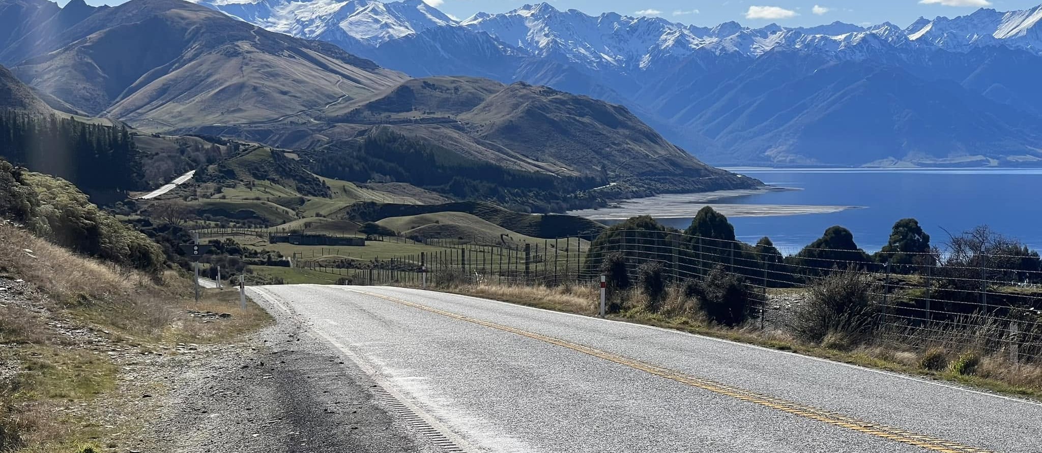 A road, a lake, mountains